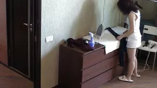 Petite dame ironing her clothes nude in the house