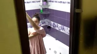 Tattooed brunette delighting a cleansing bathtub shower