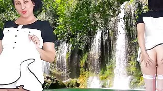 A pretty lady in a short dress shows a striptease outdoor. Pussy and ass.