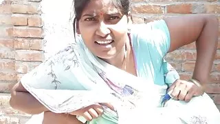 Beautiful Indian bhabhi pissing on her house roof and fingering her cremei tight pussy