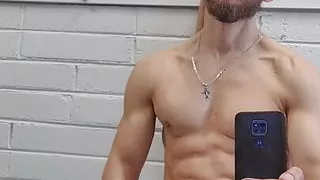 Handsome athletic man jerks off and makes selfie