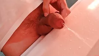 Fat uncut cock pissing in the washbasin