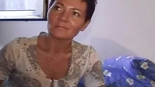 An old German lady with short hair having some fun with a long dong