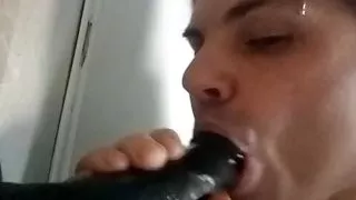 Transgirl Tiffany Deep Throats a massive black Dildo.