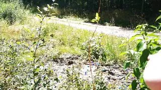 Titslapping in nature while cars drive past