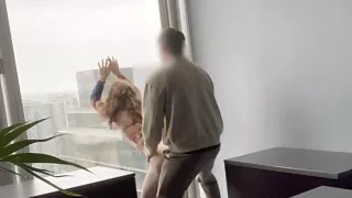 MILF boss fucked against her office window