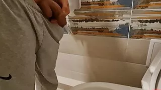 Young boy Mikel pissing at home