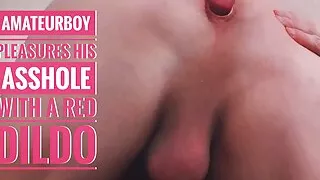 Amateurboy pleasures his tight asshole with a red dildo