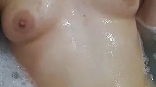 Sexy submissive teen playing with soapy boobs