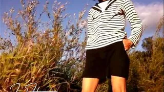 Cute sailor boy in short shorts is doing a striptease to show off his slim naked twink body outdoor