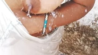 Village bhabhi bathing outdoor and showing sexy boobs