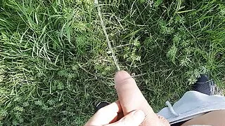 Young boy is pissing Outdoor
