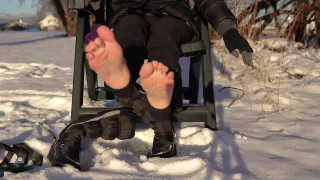 Winter Shoeplay Dangling Winter Boots Showing Soles And Wiggling Toes On Snow