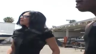 India Summer is a natural boobed brunette MILF who sits on a couch, taking her interracial lover's pants off