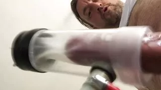 Milking machine sucks big cock while standing