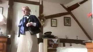 In bourgeois dress with a blue and white blouse