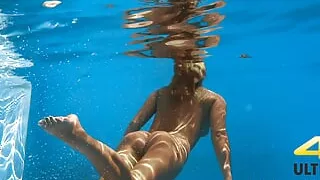 Eyla Moore, a famous model, glides elegantly through the water