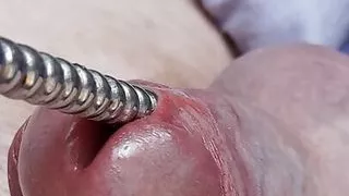 Sounding with a close up cum load through penis plug