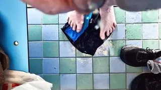 Pissing on my bare feet and swimming trunks in the changing cubicle of the local pool