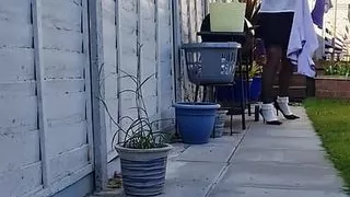 Sexy girl hanging the washing out.
