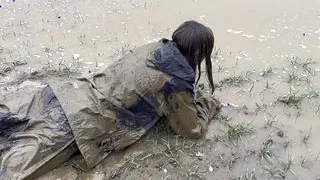 Muddy fields, rain suit in the rain