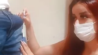 seamstress measuring customer's pants with erection