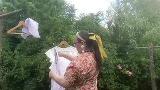 In vintage floral pattern dress for a day hanging laundry