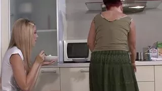 Mom and lesbian teen have fun on the kitchen