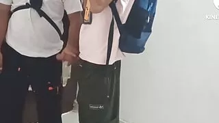 Two college students having gay fun in school library