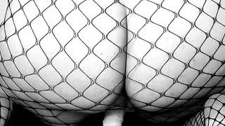 Spanish slutty milf whore fucks her dildo seen from behind.  In a fishnet dress.  Johnny Cash