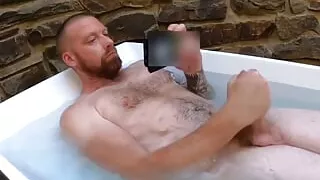 Hot bearded man jerking off in bath and cumming hard