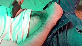 a young hot guy watches porn on his phone and jerks off his small cock.