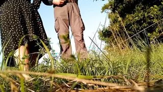 Mother-in-law in a new dress bends over and pisses in nature with her son-in-law