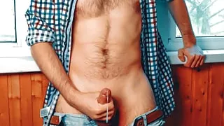 Handsome guy with a perfect body jerks off on the balcony and tries to cum very quickly