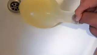 young german twink pissing in condom till its completely full and blown up like a baloon and jerking off after this relief
