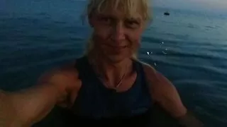 Alexa Cosmic swimming in the sea after sunset in clothes. Wetlook in sneakers, shorts and t-shirt