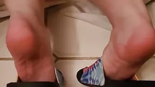 Soles of My Feet in Flip Flops While Getting the Tub Ready