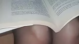 The religious lady reading a book in the living room