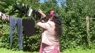 Hanging laundry in sexy pink skirt