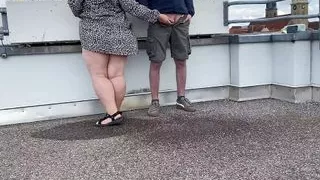Gorgeous pissing mother-in-law helps son-in-law piss on the top of the parking lot