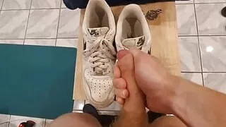 Young teen jerking off on his leather shoes while standing
