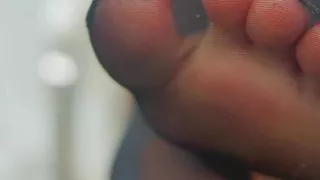 feet in pantyhose and saliva close-up
