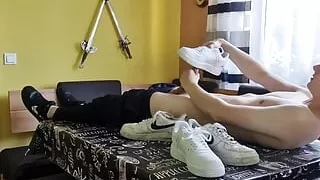 Young boy having fun at the dining table with sneakers