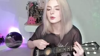 Hot blonde girl playing on ukulele and singing in naughty outfit