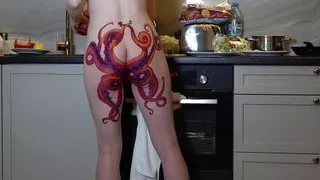 Naked housewife with octopus tattoo on butt cooks dinner on kitchen and ignores you