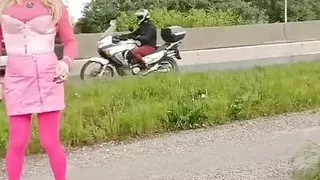sissy walks around in mini skirt and pink corset and shows her ass to motorists