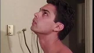 Bisexual male couple have threesome with big breasted brunette indoors