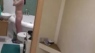 My brunette girlfriend doing her makeup in the bathroom naked