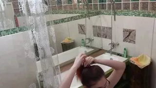 My redhead girl washing her shaved pussy with a showerhead