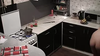My naked girlfriend making dinner in the kitchen
